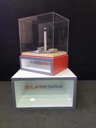 SolarReserve branded plinth with a clear acrylic display case over a scale model