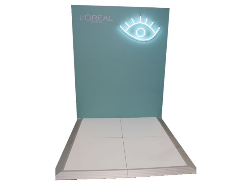 Small booth backdrop with custom lighting feature mounted to frame