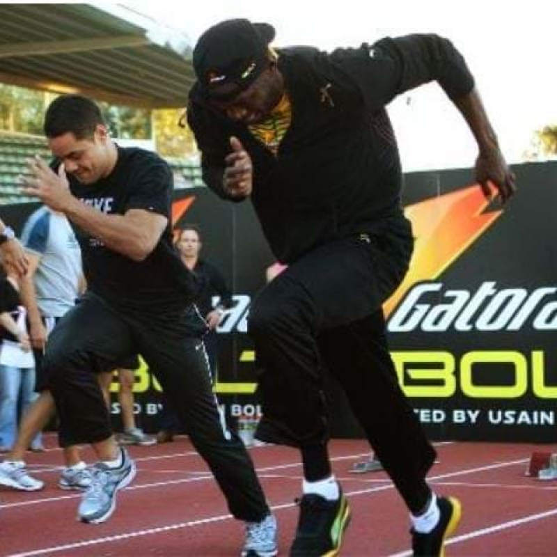 Usain Bolt training session at Olympic Park, featuring Jarryd Hayne and backdrop signage