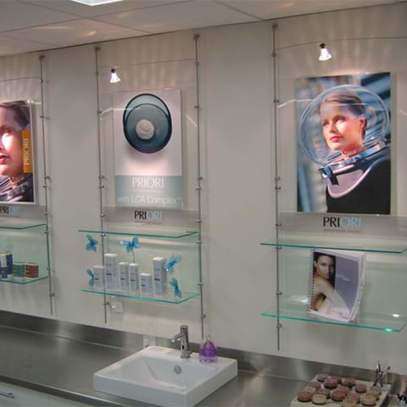 Wall display system with clear shelves and wire supports